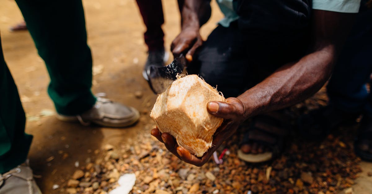 How to keep opened coconut safely? - Person Slicing Coconut Fruit