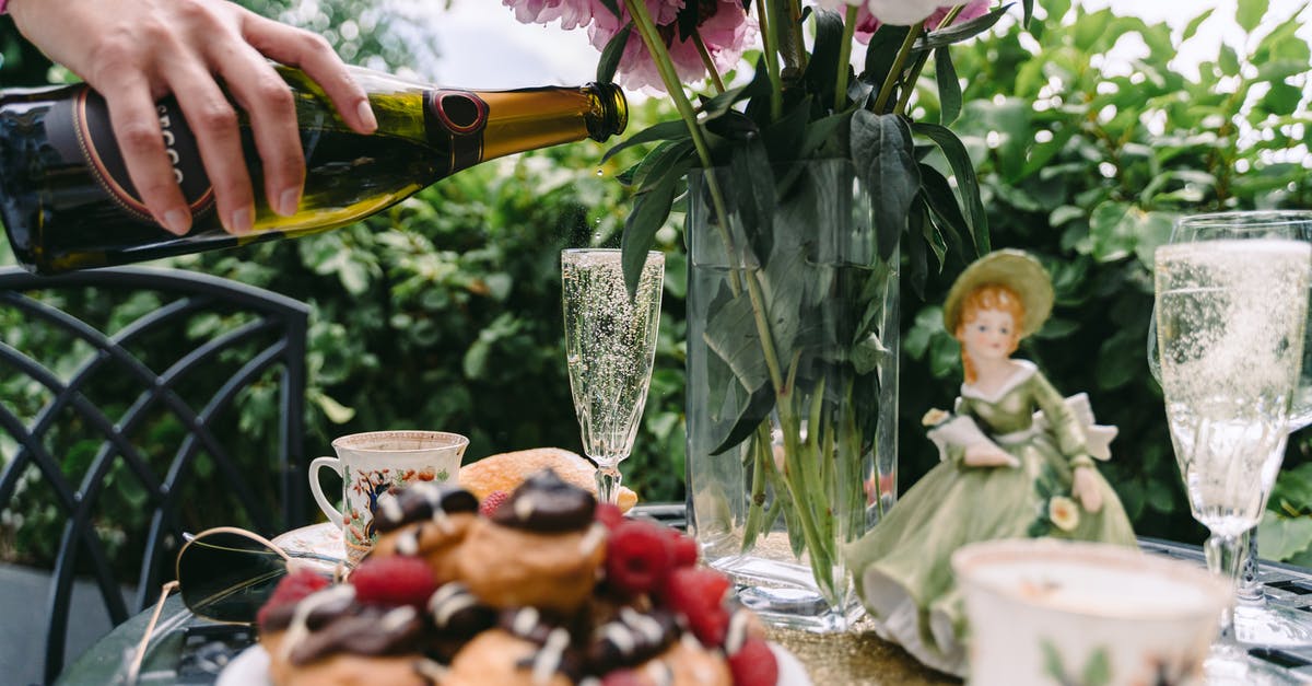 How to keep profiteroles fresh - Crop faceless woman pouring champagne into glass placed on served table on veranda