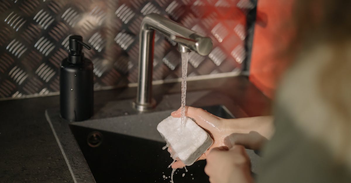 How to keep thin sponge bases moist? - Person Holding White Paper Near Stainless Steel Faucet