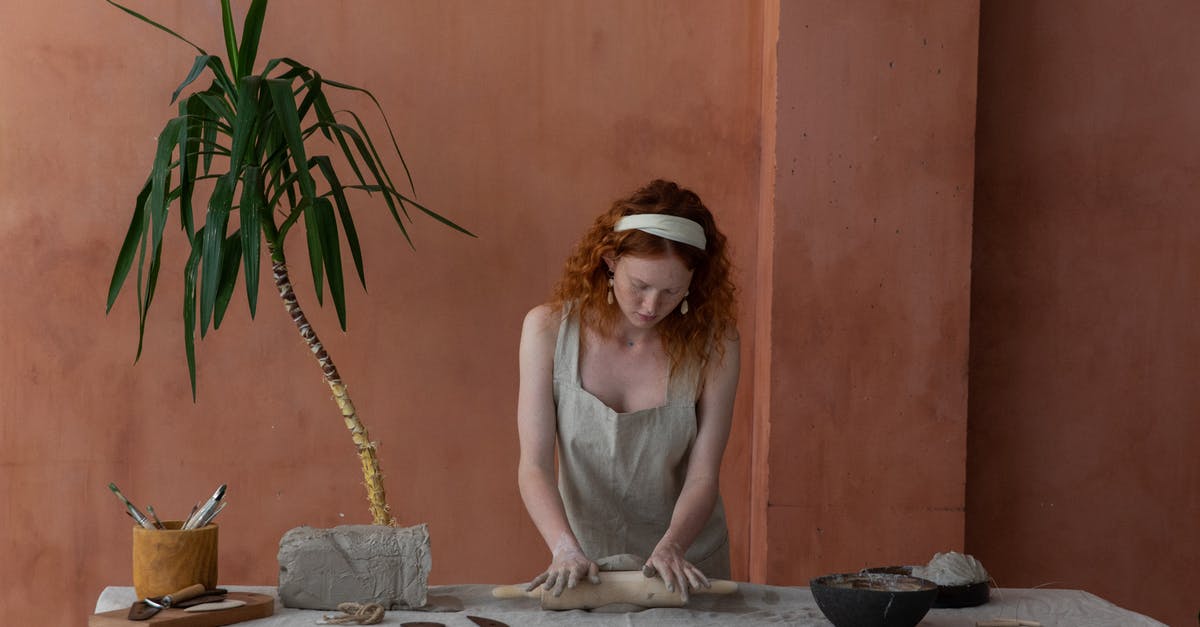 How to make a good pie dough like the industrial one? - Concentrated craftswoman rolling out clay slab in workshop