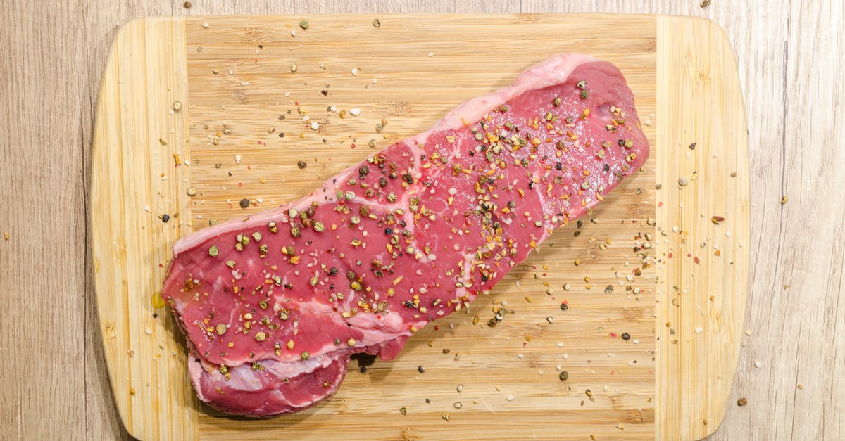 How to make a pepper crusted steak - Flat Lay Photography of Slice of Meat on Top of Chopping Board Sprinkled With Ground Peppercorns
