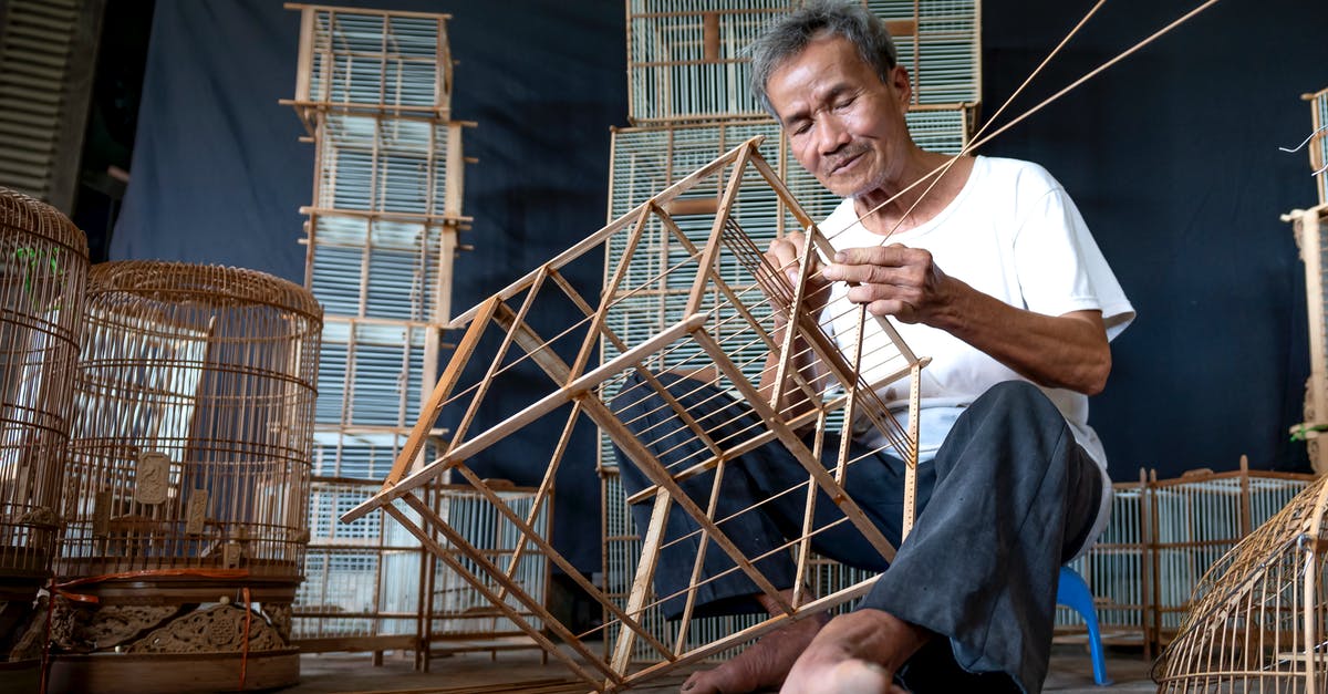 How to make Chinese-style cornstarch coating stick - Senior concentrated Asian man creating bird cages