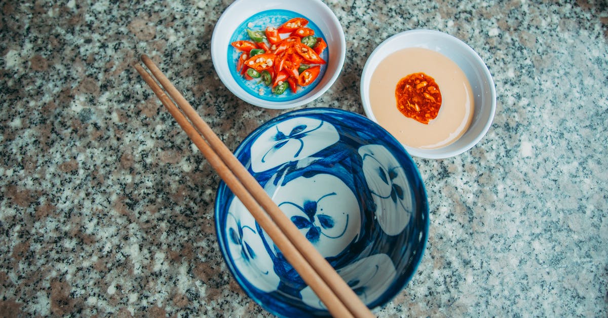 How to make Coconut/Chili Sauce (based on Photos) [closed] - Wooden Chopsticks on Blue and White Floral Ceramic Bowl Beside Saucers with Chili Peppers