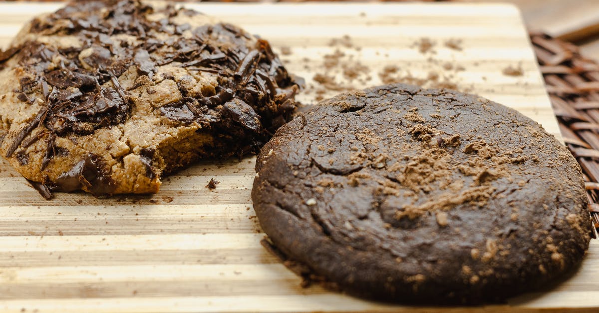 How to make crackle top chocolate chip cookies? - Closeup of baked cookies with chocolate on wooden board on table at home