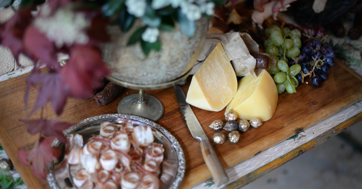 How to make extremely dry pork more palatable? - From above of served wooden board with bacon plate cheese and grapes near knife and bunch of flowers