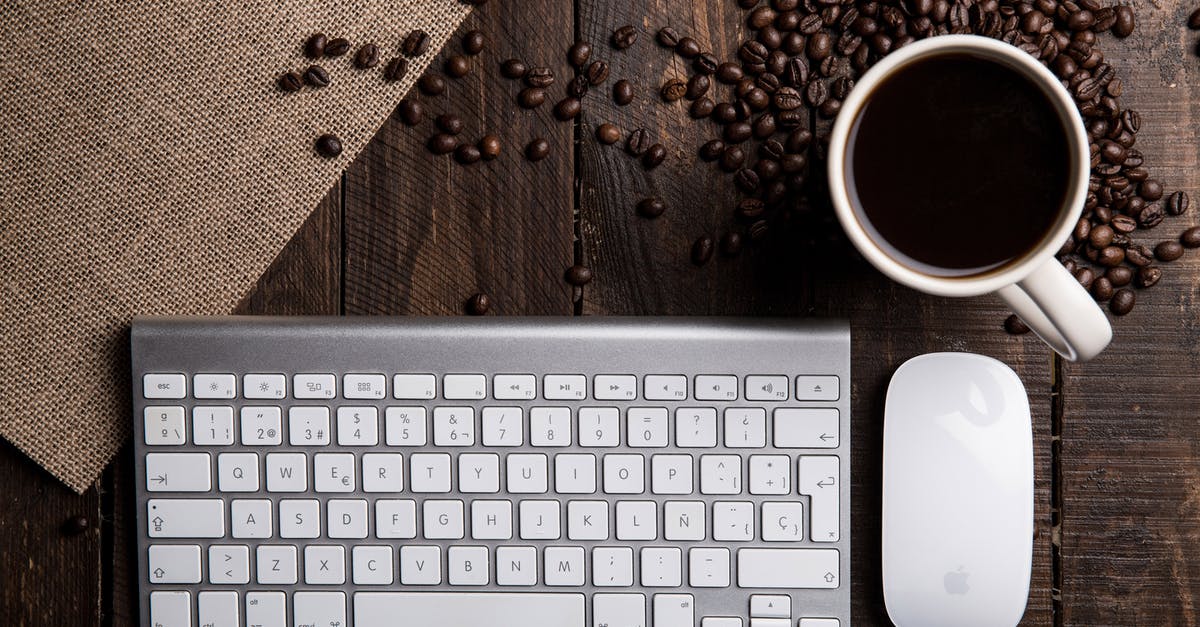 How to Make Hazelnut Roasted Coffee - Flat Lay Photography of Apple Magic Keyboard, Mouse, and Mug Filled With Coffee Beside Beans