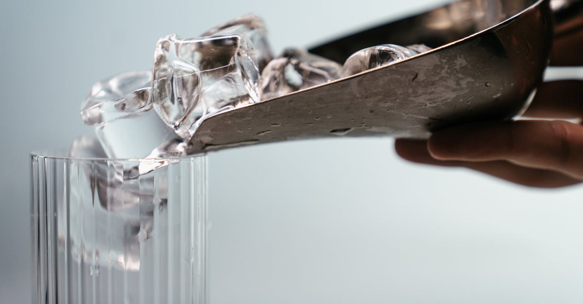 How to make large clear ice cubes - Person Holding Clear Glass Mug