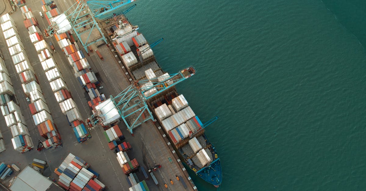 How to Make many pizzas for large party? - Top view of harbor with containers and cargo ships located near calm rippling sea water