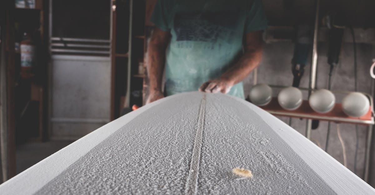 How to make modeling chocolate shiny? - Crop artisan shaping surfboard in workshop