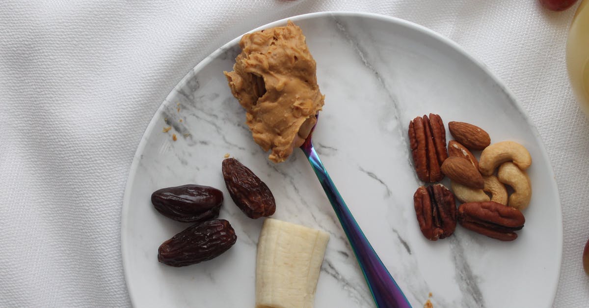 How to make peanut butter less dry - Nuts and Slices of Banana on White Ceramic Plate with Spoon of Peanut Butter