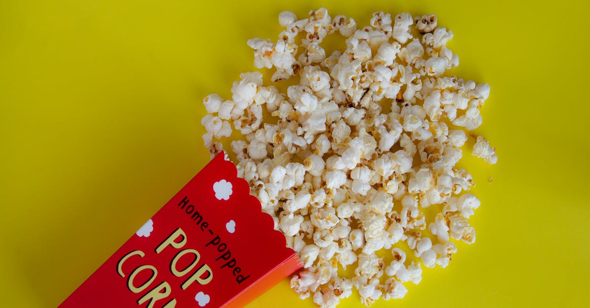 How to make perfect crunchy popcorn? - Pack with spilled popcorn on yellow background