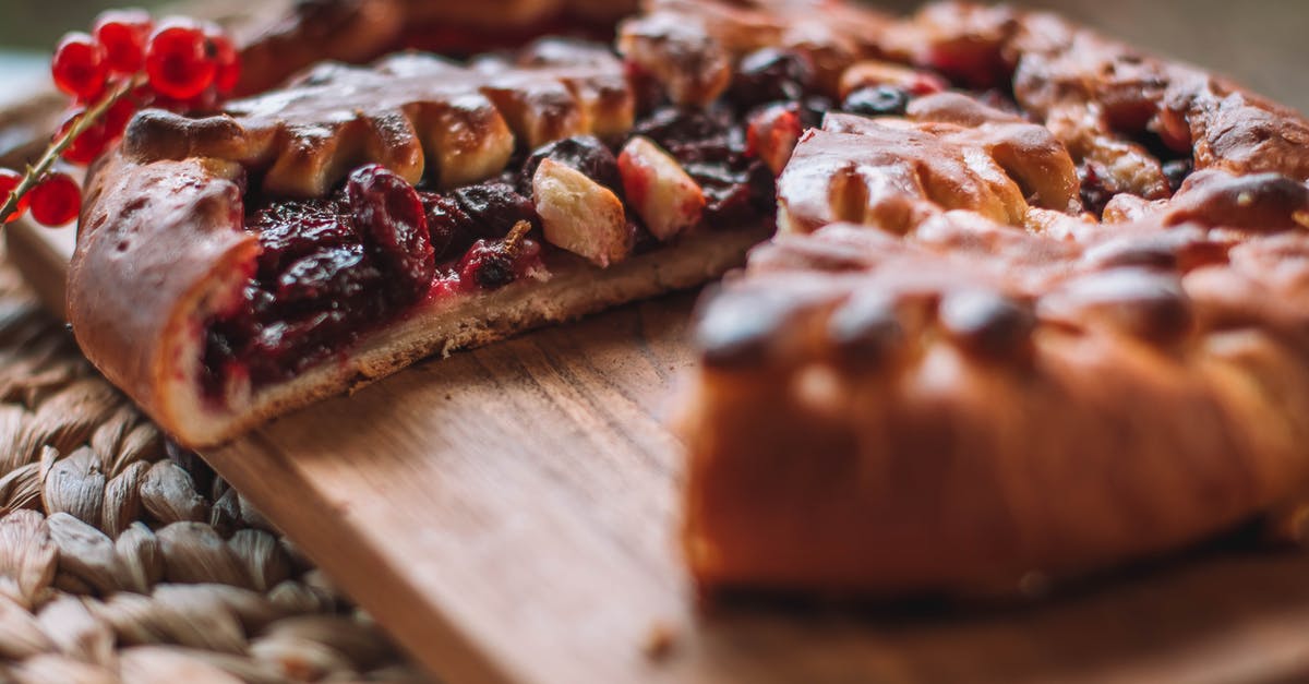 How to make pie filling which tastes like yogurt icecream? - Cut fresh baked pie with berry filling served on wooden chopping board on wicker mat in light room on blurred background