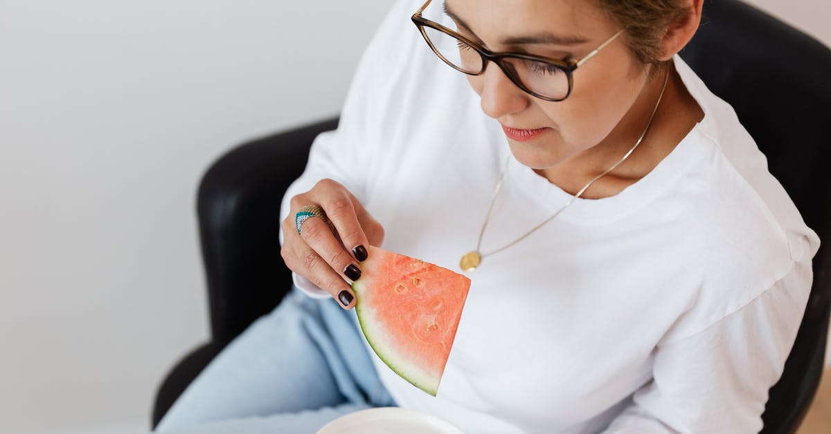How to make sorbet from fruit like watermelon? - Crop woman eating sweet ripe watermelon sitting in armchair during break