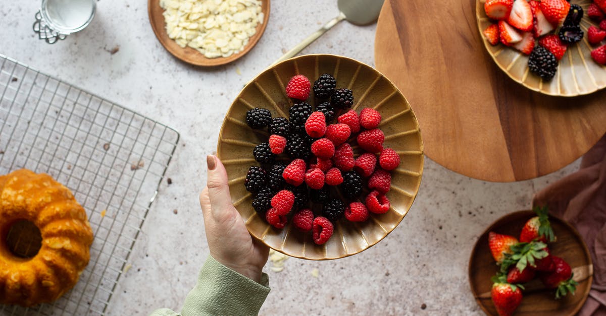 How to make sugar coated fennel seeds at home? - Person Holding Bowl of Strawberries