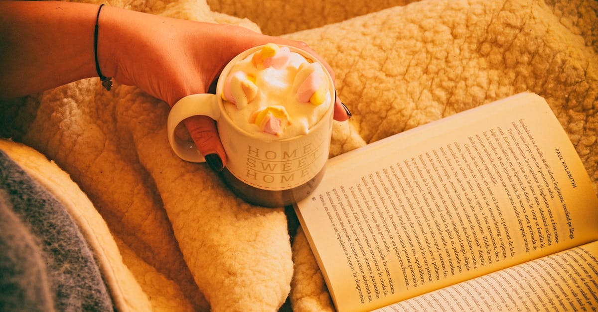 How to make the marshmallow swirl for Chocolate Marshmallow Ice cream from scratch? - Person Holding Mug Filled With Pastry Beside Open-book