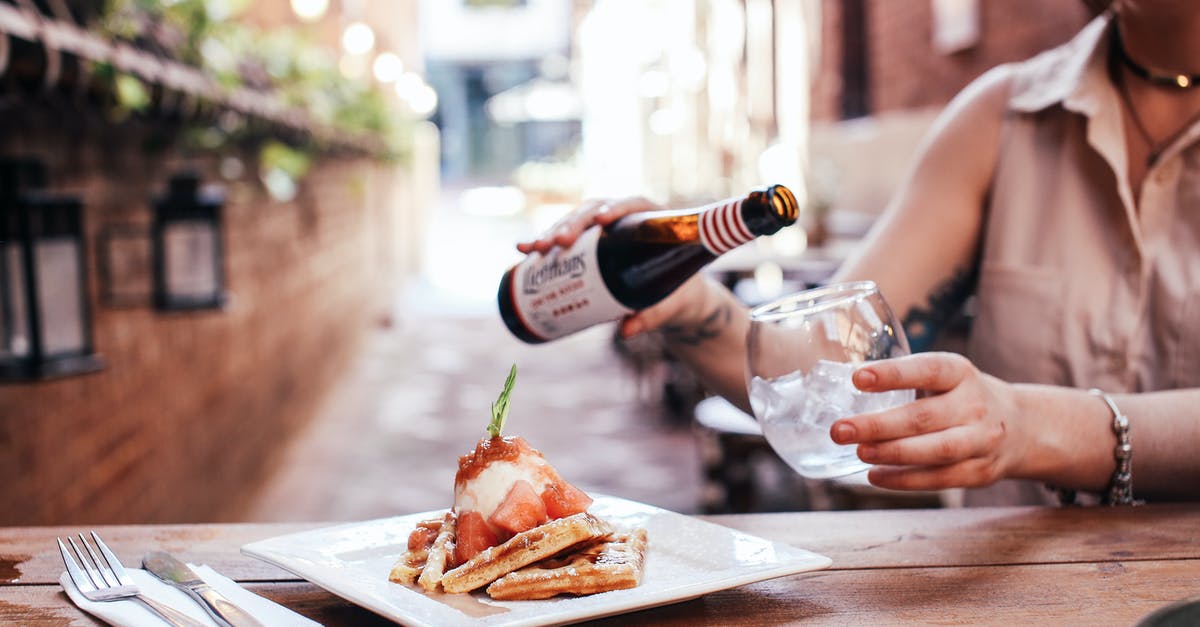 How to make the perfect root beer - Person Pouring Wine on Brown Wooden Table