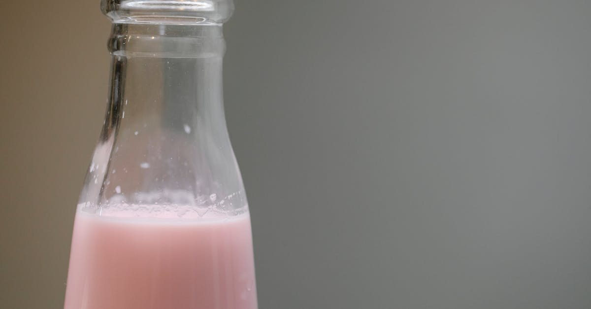 How to mark yogurt jars? - Glass bottle with tasty pink milk shake placed in room against blurred gray background