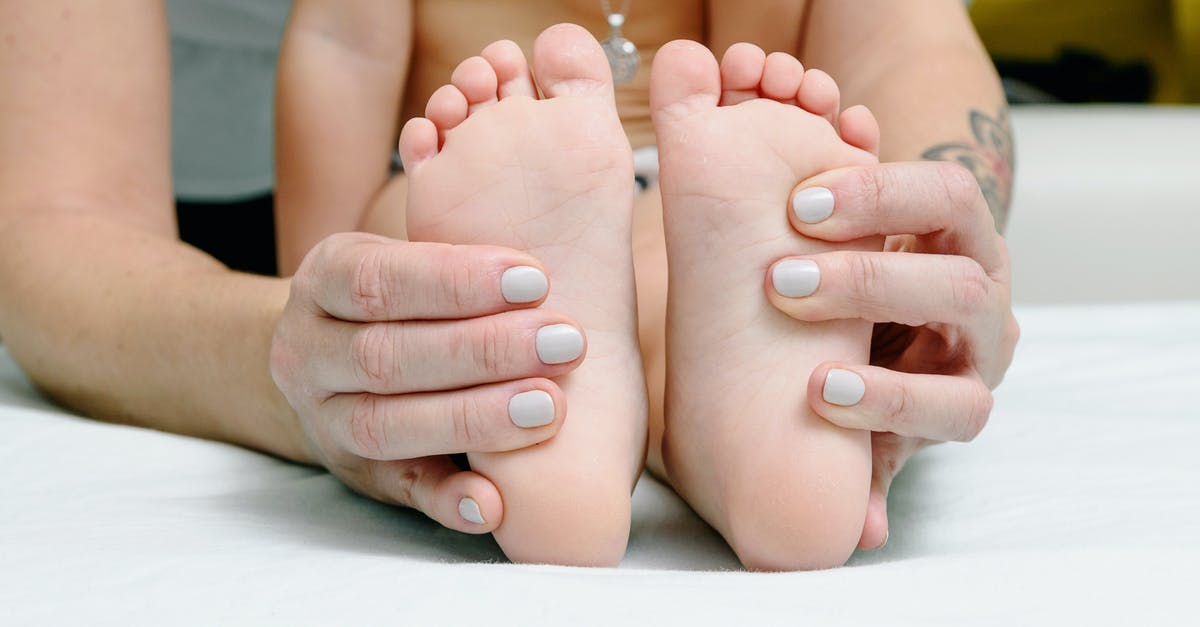 How to massage an octopus? - A Woman Massaging a Child's Feet