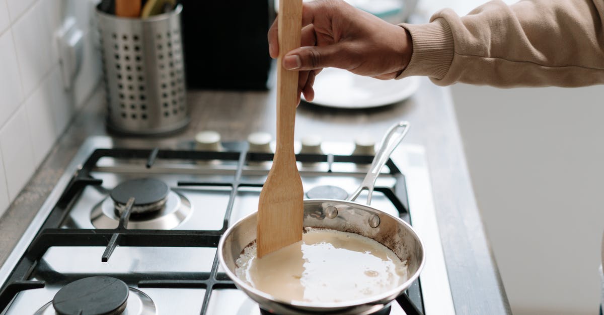 how to mix wine into cream sauce (or cream into a wine sauce) so it doesn't curdle - Person Holding Brown Wooden Ladle on a Pan