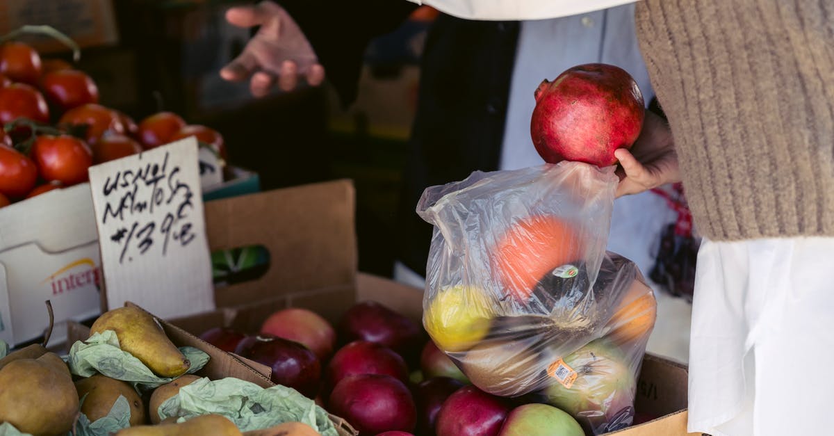 How to not buy the bad apple? - Crop woman choosing assorted healthy fruits in street market