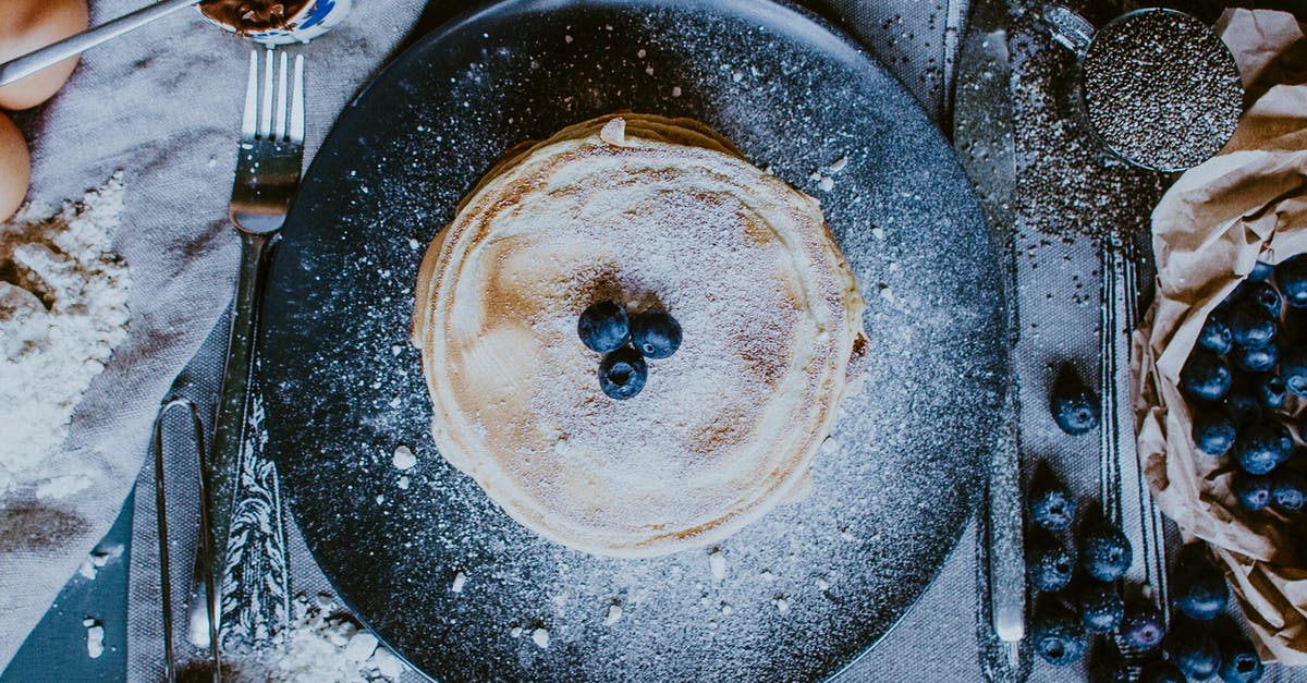 how to not get burned keto flour pancakes? - From above of plate with yummy homemade golden crepes with fresh blueberries for breakfast