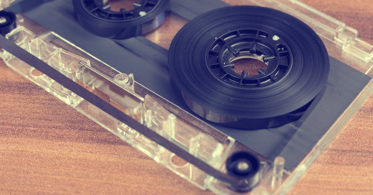 How to open this plastic cap? - Clear and Black Cassette Tape on Brown Wooden Surface