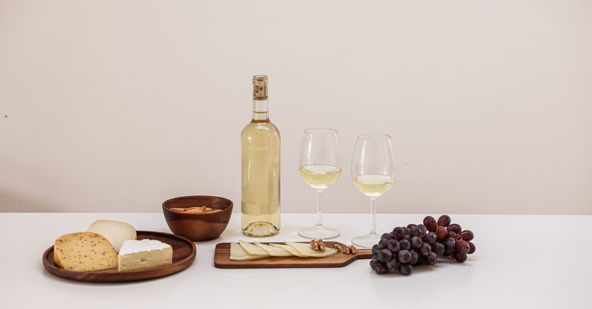 How to pair cheese with wine? - Glasses of Wine and a Variety of Cheese on a Table
