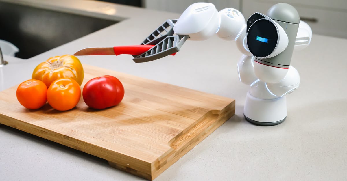 How to peel tomatoes easily? [duplicate] - White and Black Robot Toy on Brown Wooden Chopping Board