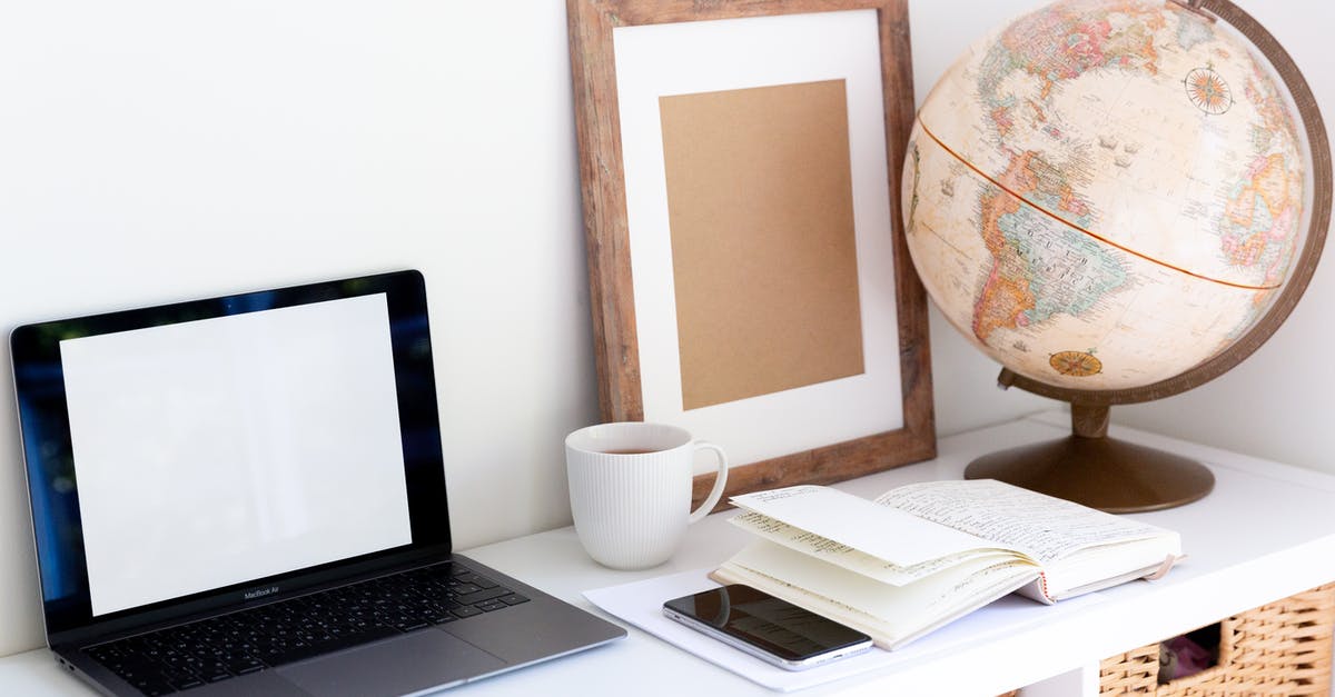 How to prepare soup for an office potluck? - Laptop with empty screen placed near smartphone and organizer with blank frame and retro glove aside during coffee break in room