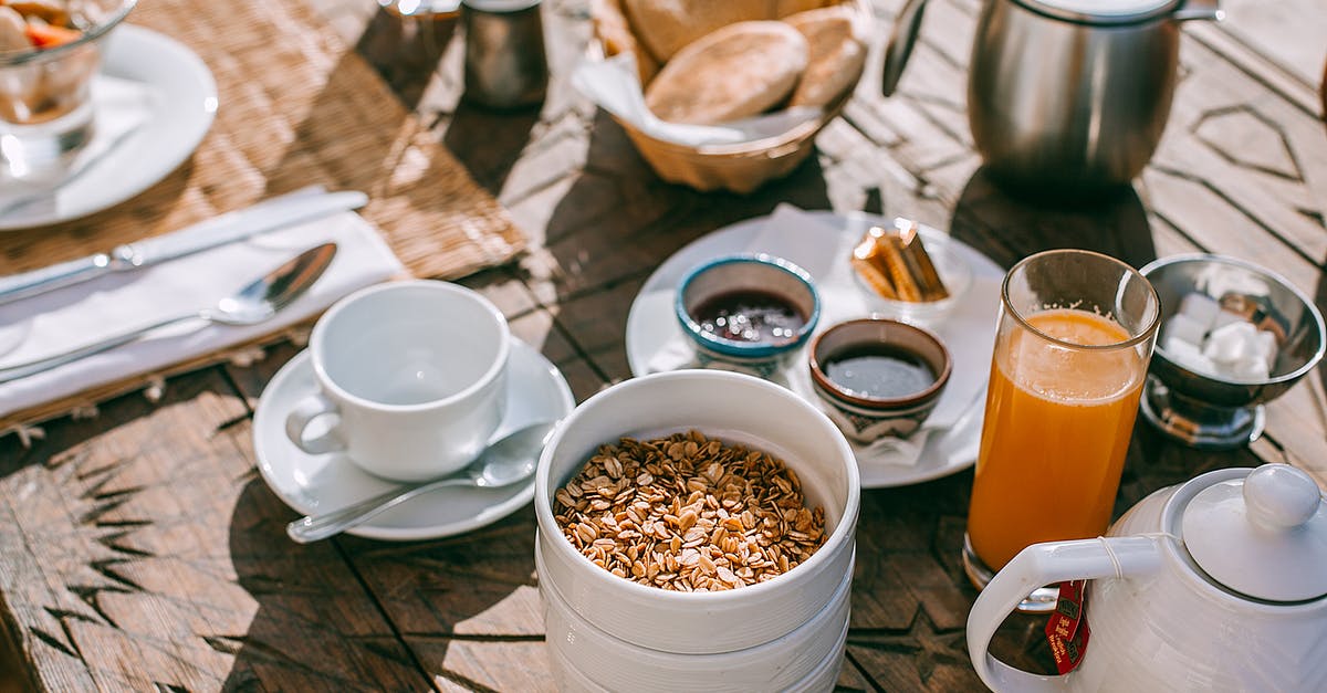 How to prepare tasty tea on induction cooktop? - Served table with breakfast on street