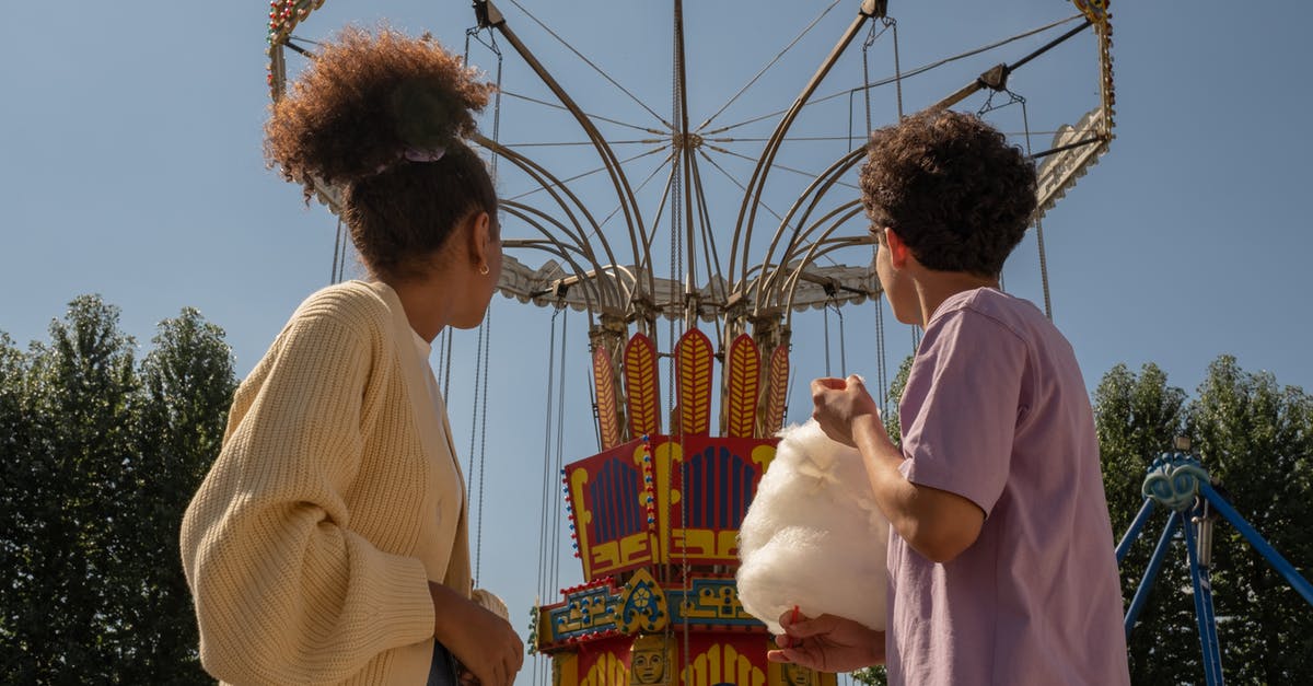 How to preserve cotton candy - Teenage couple on date in amusement park looking at big carousel