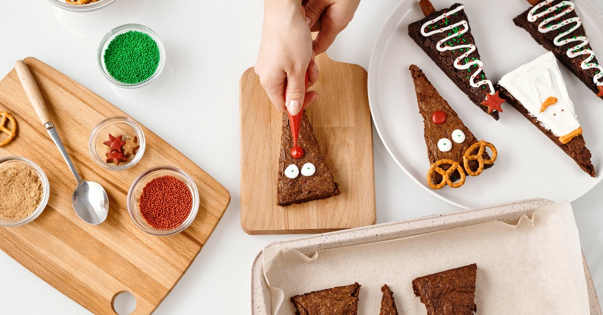 How to prevent a cookie from becoming spongy like a cake? - Top View of a Person Decorating a Triangle Shaped Cake