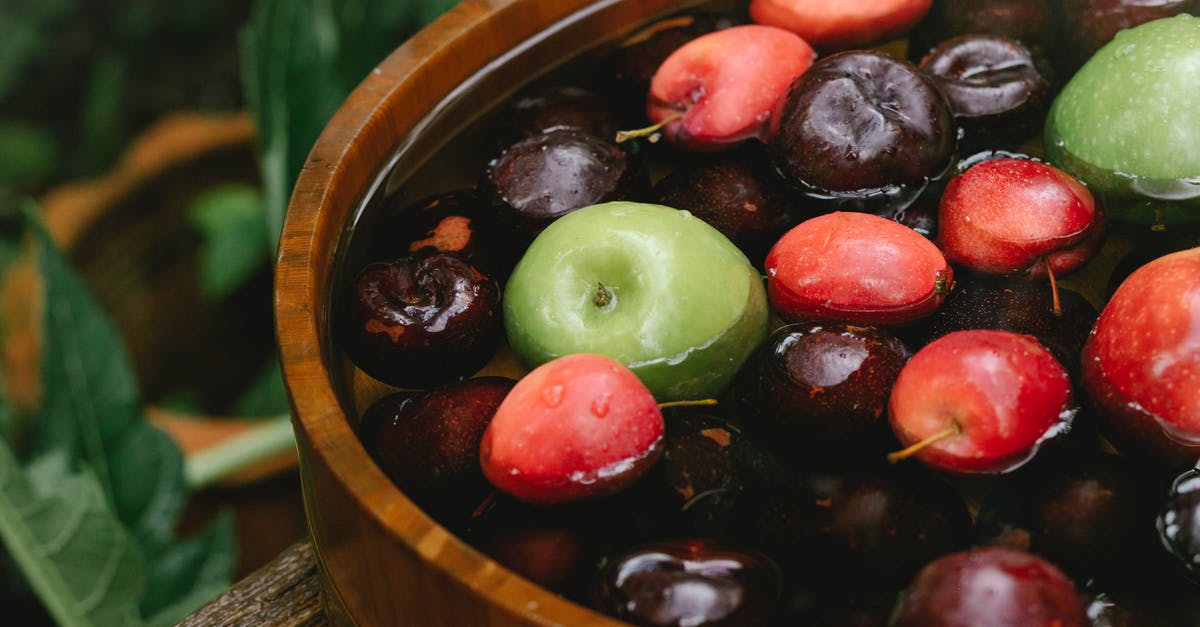 How to Prevent Apples from turning Brown - Closeup of ripe delicious tasty fruits in wooden bowl in forest in daylight