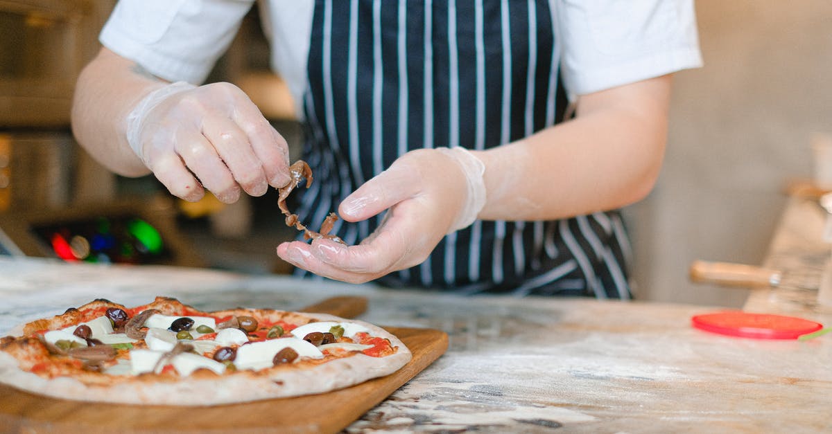 How to prevent crust forming during frying, baking and grilling? - Person Preparing A Pizza