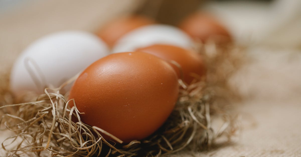 How to prevent dry chicken in soup? - Fresh chicken eggs placed in straw on table with cloth in soft focus