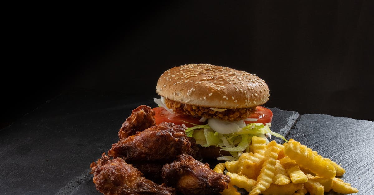 How to prevent the breading residue sticking in chicken fry? - Chicken burger with chicken wings and french fries
