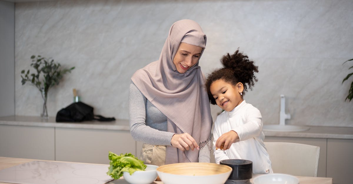 How to properly cook a kid? - Happy diverse mother and daughter cooking together