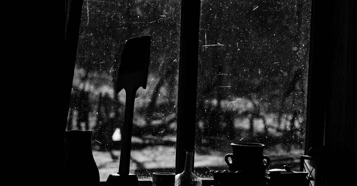 How to properly handle an all clad pan - Black and white of jugs with cup and pan against window in aged building in countryside