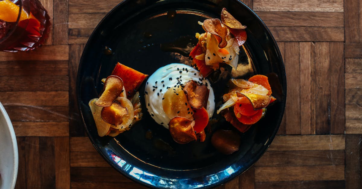 How to properly poach an egg? [duplicate] - Top view of platter with appetizing poached egg with mushrooms and vegetables sprinkled with black sesame seeds