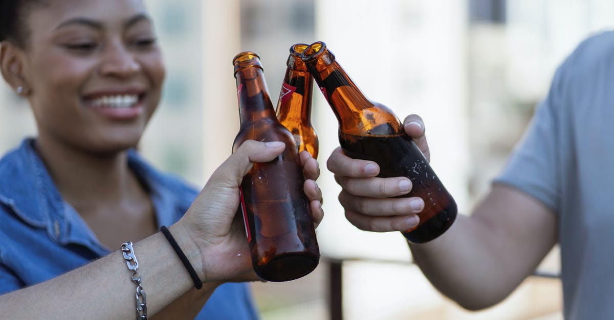 How to properly use alcohol when cooking something? [closed] - Woman Holding Brown Glass Bottle