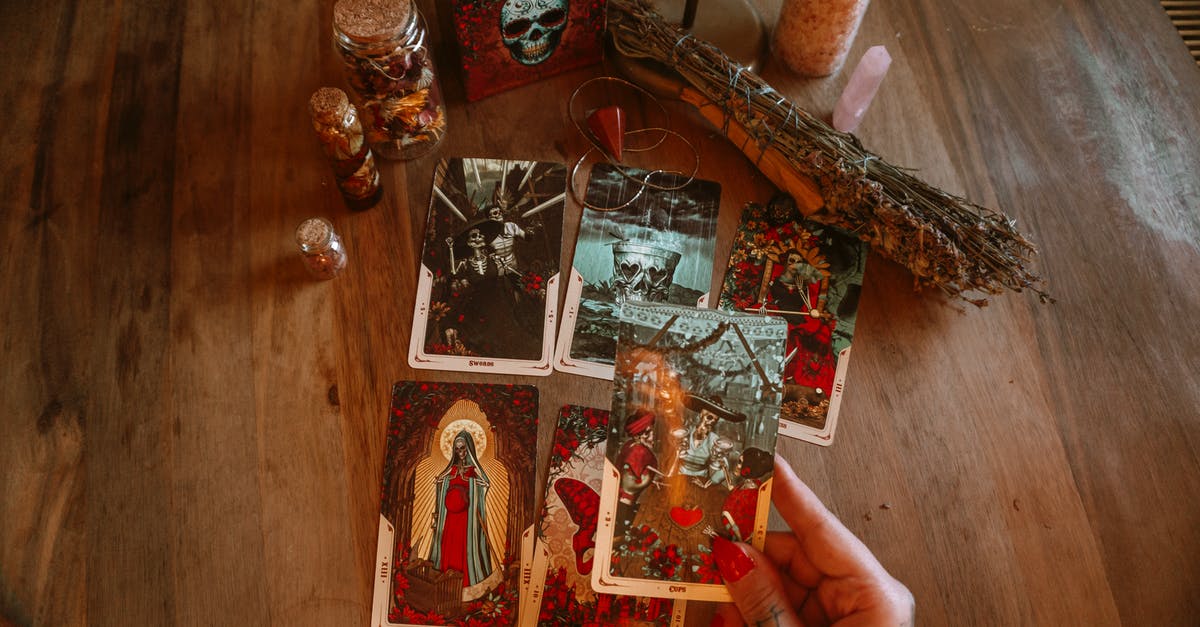 how to quickly dry out home made marshmallows? - From above of crop unrecognizable tattooed female soothsayer showing tarot card with image above table with decorative bottles and amulet