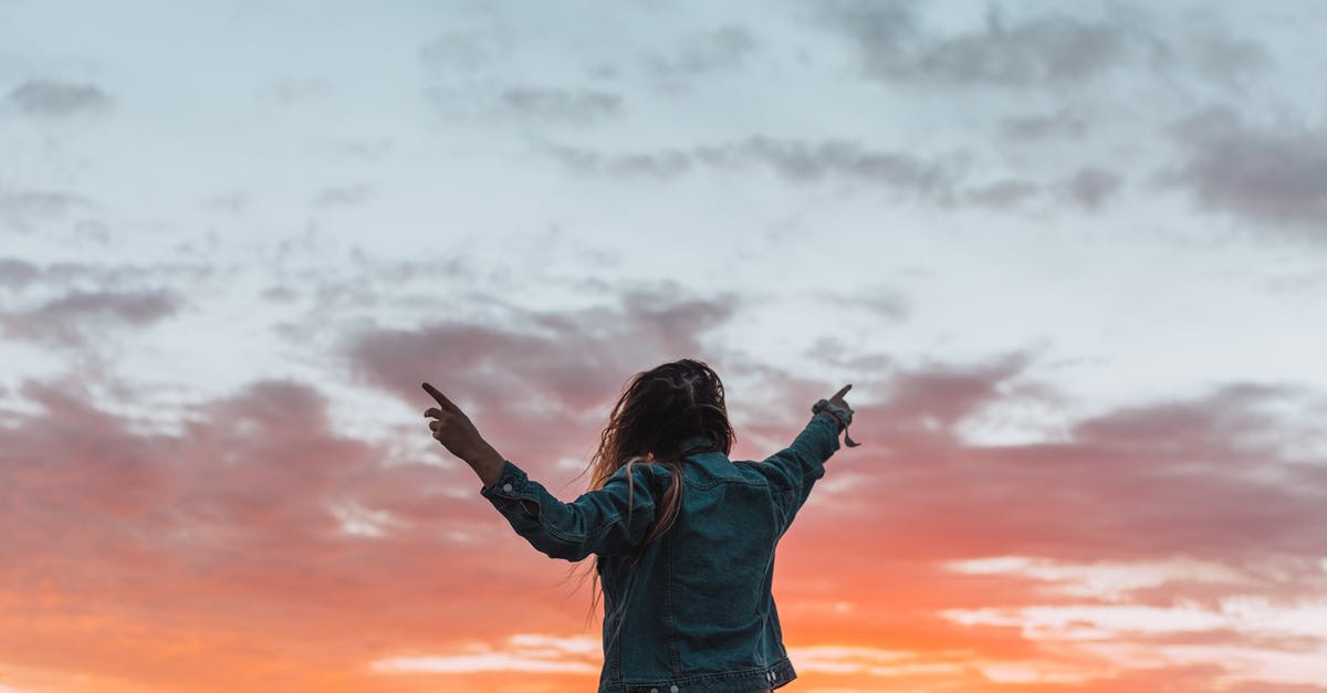 How to raise the setting and melting point of gelatin - Back view of anonymous female in denim apparel showing colorful cloudy sky with fingers while contemplating sundown