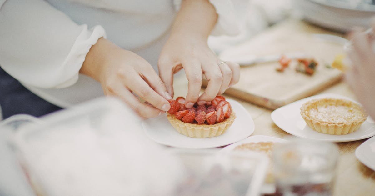 How to reduce the moisture when making tarte tatin - A Person Making a Strawberry Tart