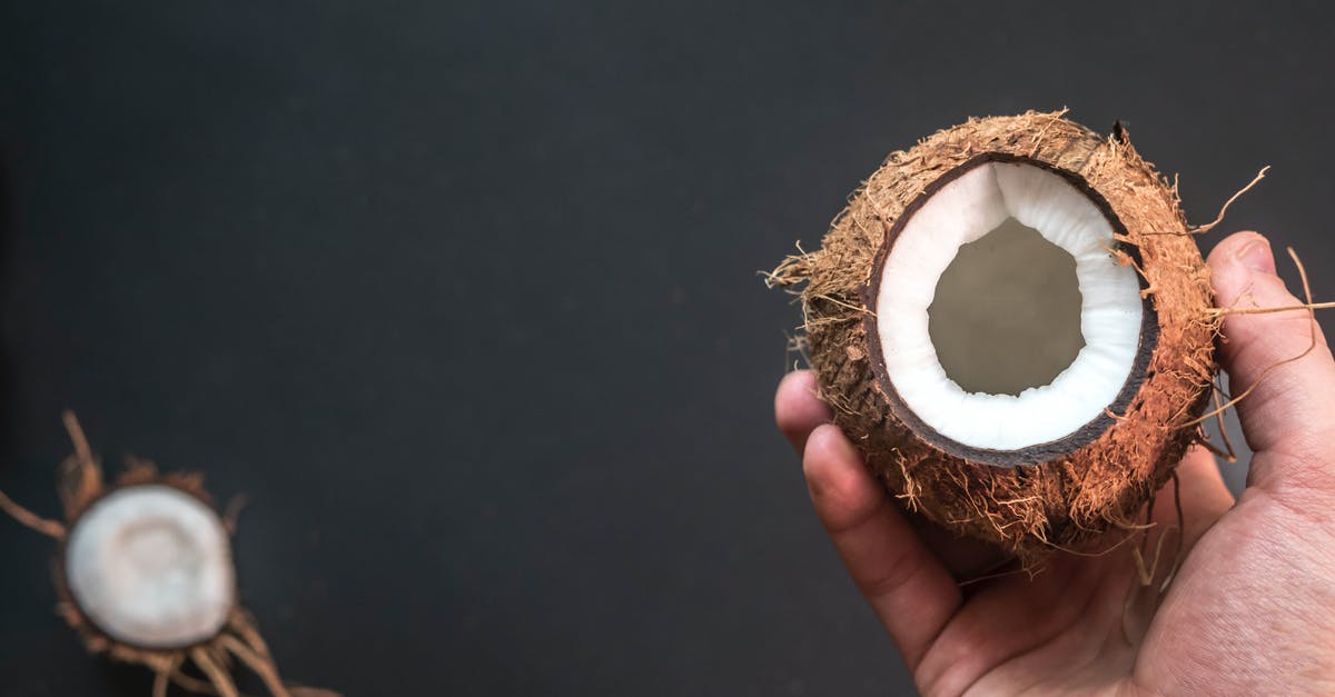 How to remoisten sweetened coconut after opening? - Person Holding Opened Coconut
