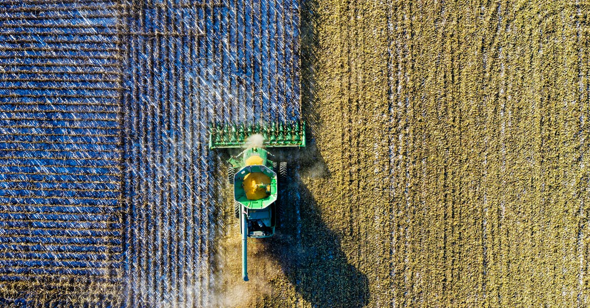 How to remove skin from field corn - Aerial Shot of Green Milling Tractor