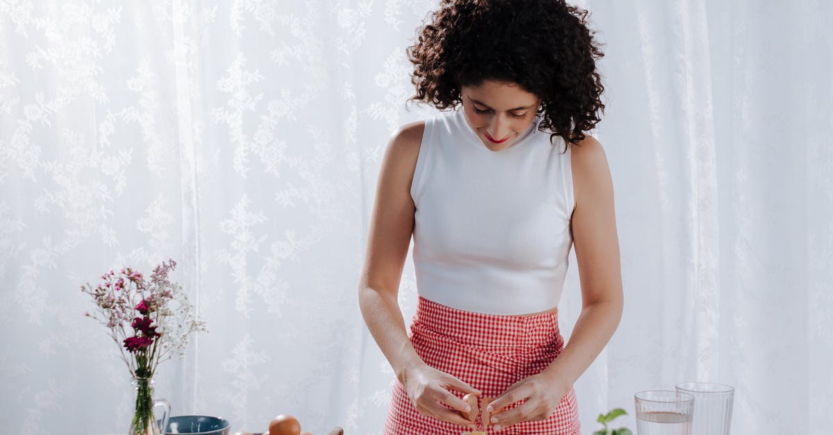 How to replace large eggs for medium in a recipe? - Woman Breaking Eggs into Flour Mound