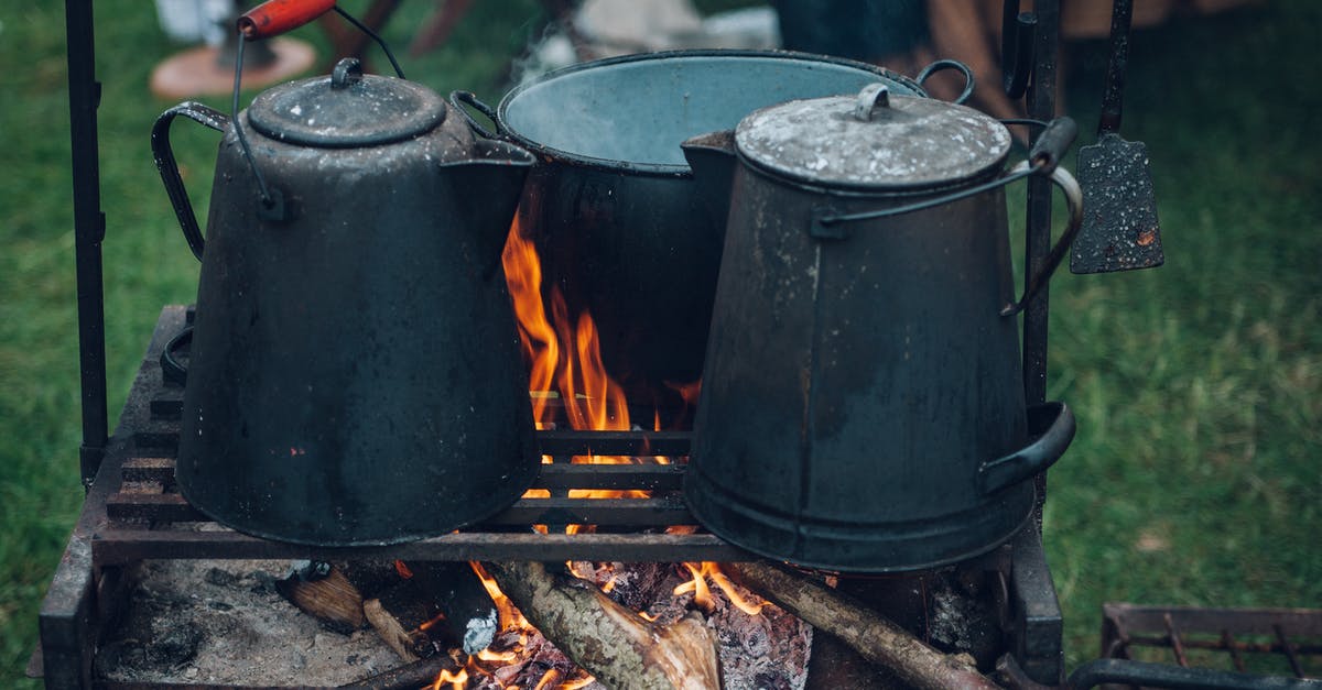 How to reseason cast iron skillets using a fire - Three Black and Gray Pots on Top of Grill With Fire on Focus Photo