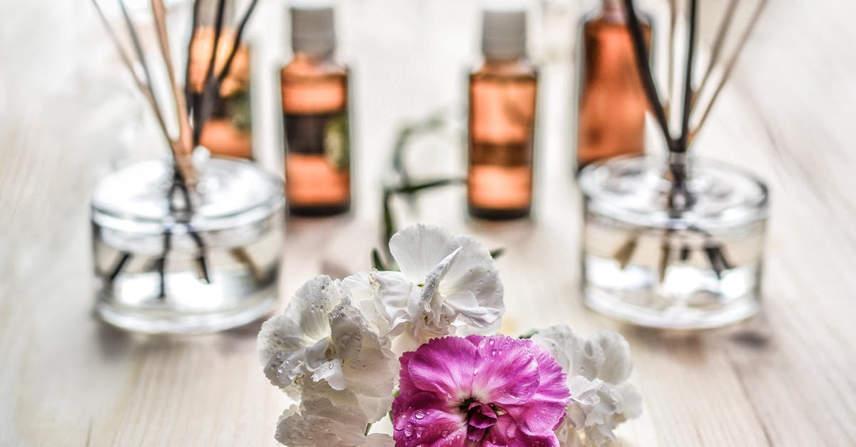 How to safely reuse glass bottles to store oils - White and Purple Flower Plant on Brown Wooden Surface