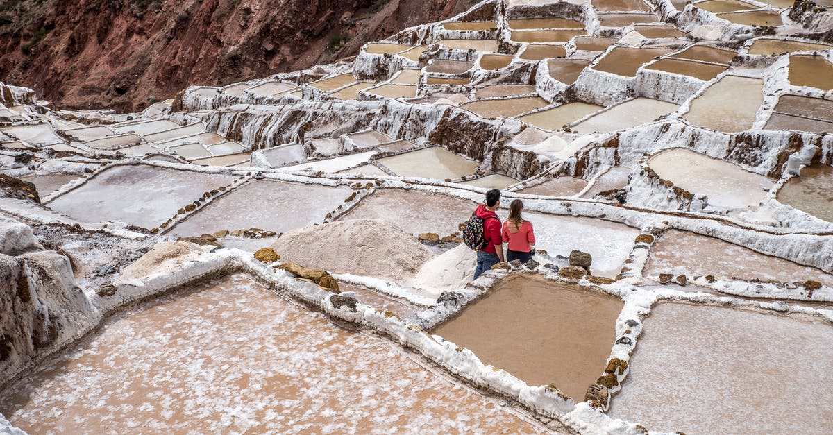 How to salt potatoes? - Man in Red Jacket Sitting on Brown Rock Formation