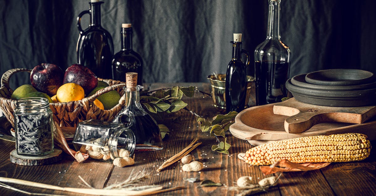 How to salvage hardened peanut butter from jar bottom - Assorted fruits and bottles on table with corn and rustic tableware